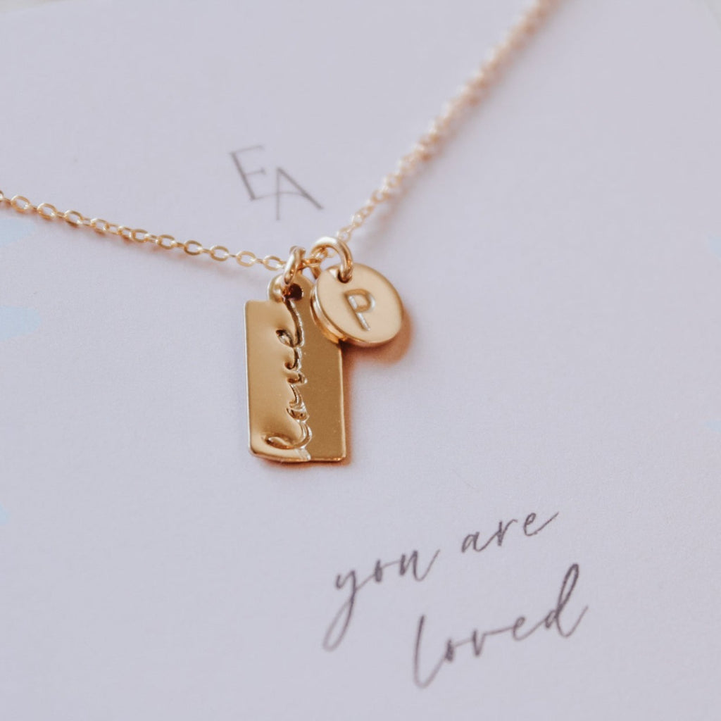 love bar initial necklace gold on card
